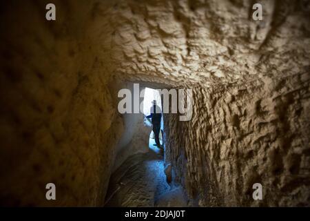 Tourist walking at tunnel of the underground City in Cappadocia, Turkey. Stock Photo