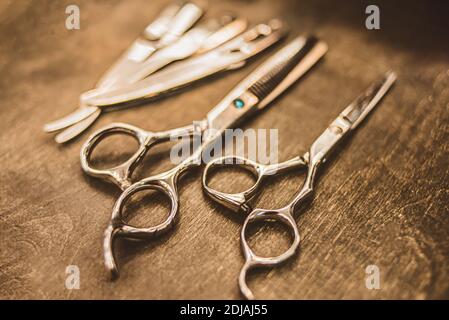metal scissors and black combs for haircuts are in the hairdresser Stock Photo