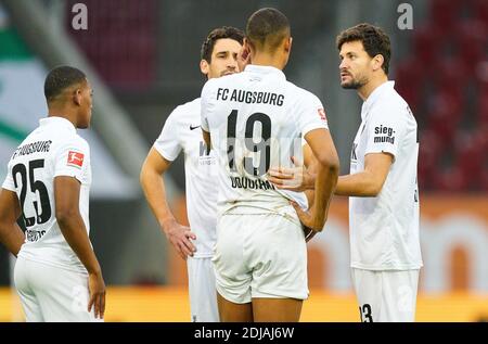 Mark UTH, S04 Nr. 7 unconscious and heavy head injury, after crash with Felix UDUOKHAI, FCA 19 consoled by fellow players in the match FC AUGSBURG - FC SCHALKE 04 2-2 1.German Football League , Augsburg, Germany, December 13, 2020.  Season 2020/2021, matchday 11, 1.Bundesliga © Peter Schatz / Alamy Live News   National and international News-Agencies OUT Editorial Use ONLY  - DFL REGULATIONS PROHIBIT ANY USE OF PHOTOGRAPHS as IMAGE SEQUENCES and/or QUASI-VIDEO - Stock Photo