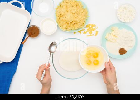 step-by-step recipe for the holiday of Hanukkah, a traditional Kugel pie with noodles and custard, sand crumbs on top. the ingredients in the dishes o Stock Photo