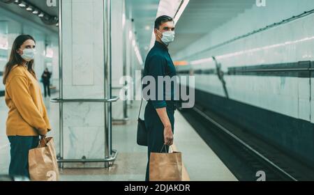 passengers in protective masks waiting for the metro train Stock Photo
