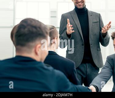 smiling employees shaking hands during a working meeting Stock Photo