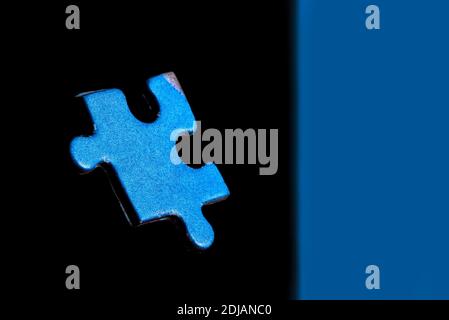 Abstract image of blue puzzle on black background floating with split background Stock Photo