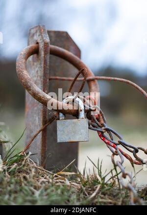 Hawser chain with a padlock on it rusted vintage on bay Stock Photo
