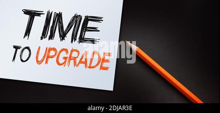 time to upgrade text write on paper. Technology and business concept. Stock Photo