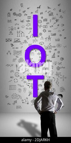 Businessman watching an iot concept drawn on a wall Stock Photo