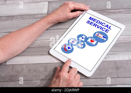 Medical service concept shown on a tablet used by a woman Stock Photo