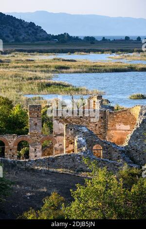 The 10 century ruines of Saint Achilleios Basilica on the island of Agios Achilleios on Mikri Prespa lake, Macedonia, Northern Greece. Stock Photo