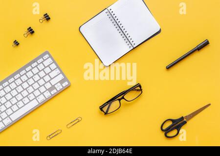 Yellow flat lay top view office table desk with keyboard and office supplies Stock Photo