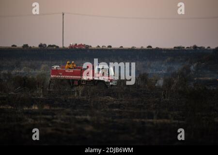 Melbourne, Australia 14 Dec 2020, A County Fire Authority fire truck moves with its crew across the burnt paddocks near Mount Cottrell. Fire Services used aircraft and fire crews to control a 110 hectare grass fire on Melbourne's outer west that destroy several sheds and cars. Stock Photo