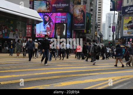 Crowd of people crossing the street in the busy district of Causeway bay in Hong Kong
