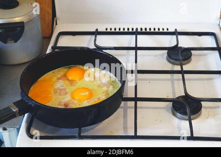 Eggs are fried in a pan. Cooking fried egg Stock Photo