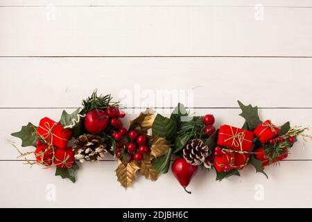 Interesting beautiful Christmas ornament decorations on white colored wooden surface texture with copy space. Stock Photo