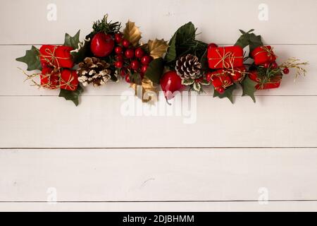 Interesting beautiful Christmas ornament decorations on white colored wooden surface texture with copy space. Stock Photo