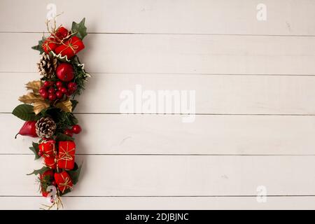 Interesting beautiful Christmas ornament decorations on white colored wooden surface texture with copy space. Stock Photo