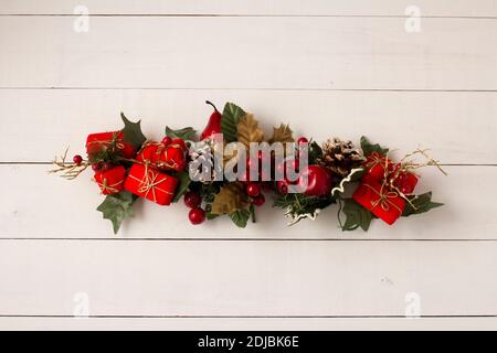 Interesting beautiful Christmas ornament decorations on white colored wooden surface texture with copy space. Stock Photo