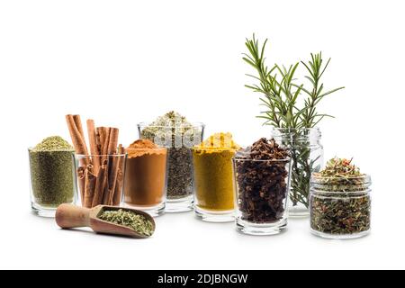 glass jars with various spices on white background Stock Photo