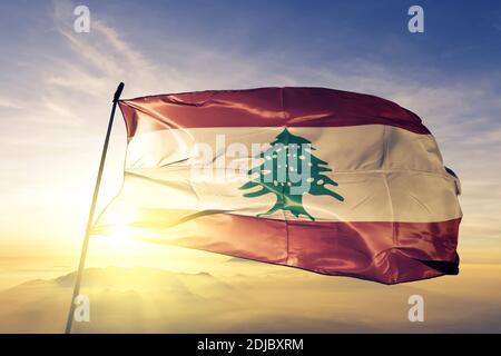 Lebanon flag waving on the top sunrise mist fog Stock Photo