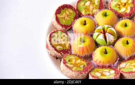 Indian sweets on a plate with copy space. varieties of colorful desserts arranged on a plate. Stock Photo