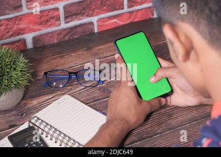 rear view of young man using smart phone  Stock Photo