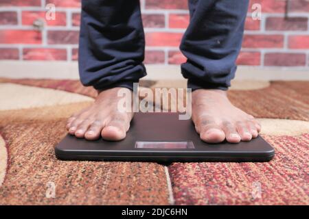 Closeup Of Man's Feet On Weight Scale Indicating Overweight Stock Photo,  Picture and Royalty Free Image. Image 33443183.