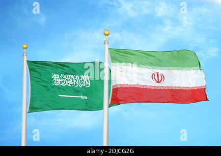 Saudi Arabia and Iran two flags on flagpoles and blue cloudy sky Stock Photo