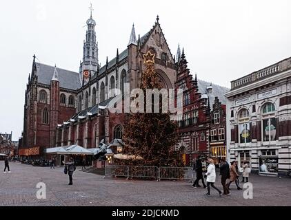 Haarlem, Netherlands 26 12 2019 New Year Christmas tree on the main street of city square. In front of the cathedral Grote Kerk. European old town on Stock Photo