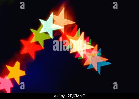 Abstract coloured star shapes  against a black background Stock Photo