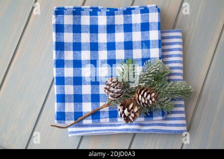 stack of kitchen napkin in a blue cage on a wooden rustic background with Christmas decoration top view Stock Photo