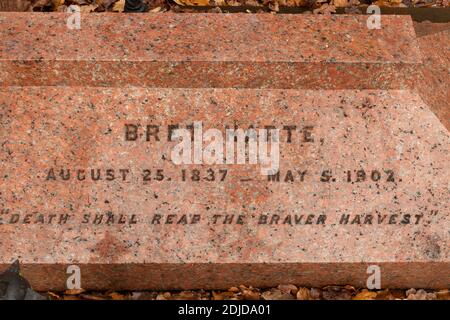 The grave of Bret Harte, American writer and poet, in the churchyard of St Peters Church, Frimley, Surrey, UK Stock Photo