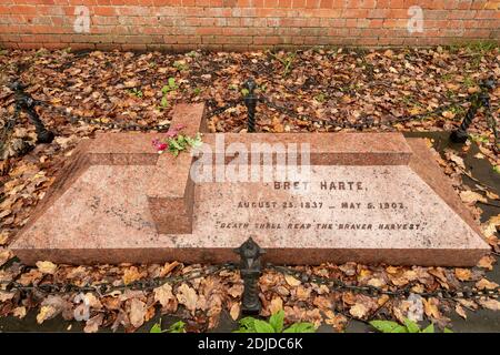 The grave of Bret Harte, American writer and poet, in the churchyard of St Peters Church, Frimley, Surrey, UK Stock Photo