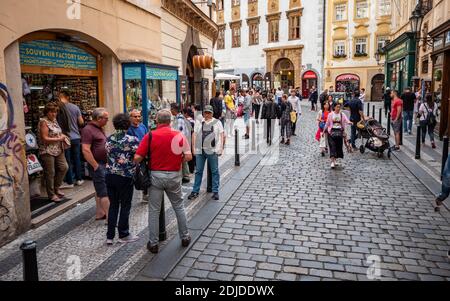 Prague Old Town tourism. The bustling cobbled back streets of the Czech Republic capital city filled with tourists and souvenir shops. Stock Photo