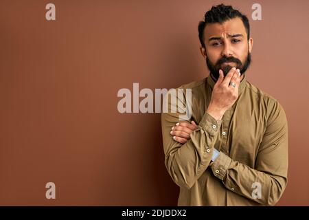confident concentrated arabic male posing isolated in studio, indian arabian modern man with deadpan expression Stock Photo