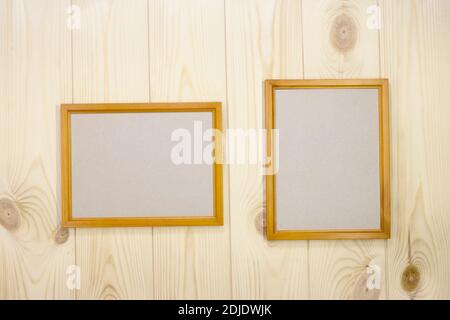 Mock up two empty wooden frames on light pine wood wall background, show text or product. Stock Photo
