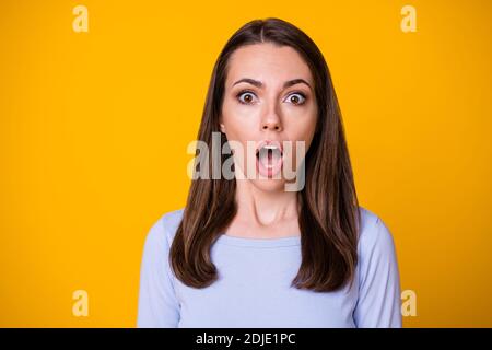 Closeup photo of attractive pretty shocked speechless lady open mouth look on camera terrified eyes listen bad awful news wear casual shirt isolated Stock Photo