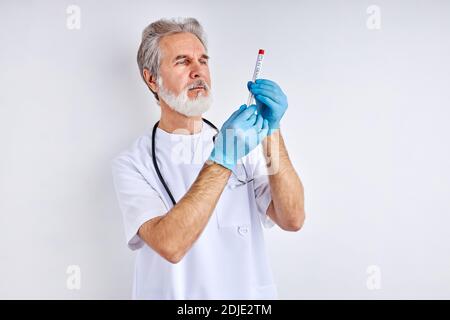 doctor holding a test tube of liquid solution in a laboratory, preparing results. epidemic pandemic coronavirus 2019-ncov sars covid-19 flu virus conc Stock Photo