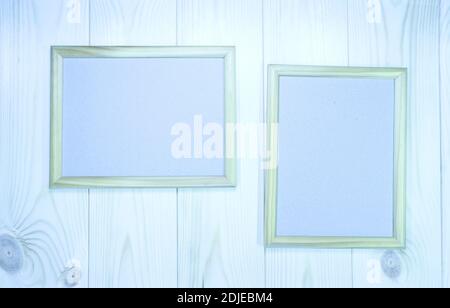 Mock up two empty wooden frames on light-blue pine wood wall background, show text or product. Stock Photo