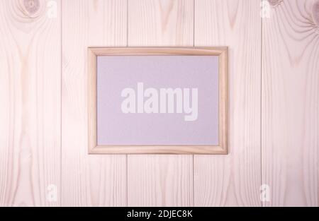 Mock up empty wood frame on light-pink pine wood wall background, show text or product. Stock Photo