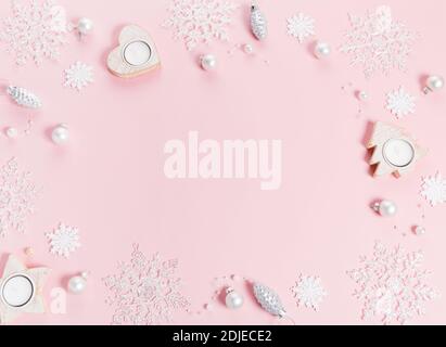Pink Christmas holiday composition. Festive creative pink pattern, xmas decor holiday ball with snowflakes on pink background. Stock Photo