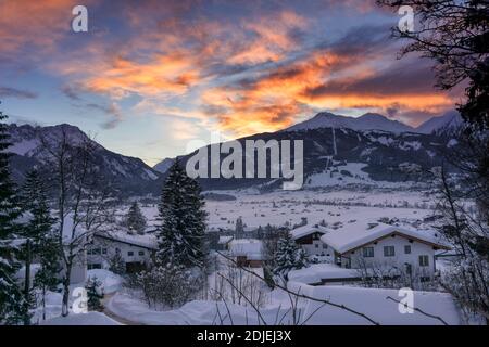 Sunset over the mountains. Winter mountain landscape. Dark blue sky with dramatic coluds. Ehrwald, Austria, Europe. Stock Photo