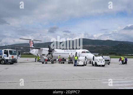 Croatia Airlines Bombardier Q400 parked on a runway  during disembarkation at Split airport, Dalmatia, Croatia, Europe. Stock Photo