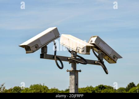 Close up view of remote controlled CCTV cameras mounted on a tall post Stock Photo