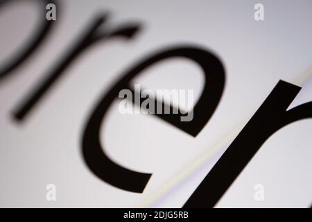 Close-up of part of black and white Lorem Ipsum text on a monitor screen with focus on the letter N at bottom right. Very narrow depth of field Stock Photo