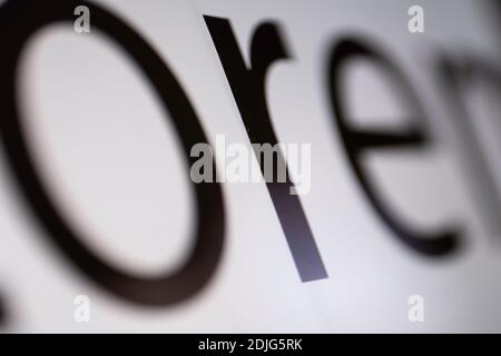 Close-up of part of black and white Lorem Ipsum text on a monitor screen with focus on the letter R in the middle. Very narrow depth of field Stock Photo