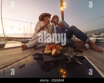 Friends Sitting On Table Against Sky During Sunset