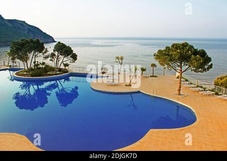 Swimming pool area near Mediterranean Sea in the morning, Turkey Stock Photo