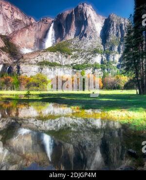 Yosemite Falls reflected in pool of water. Yosemite National Park, California Stock Photo