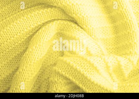 Close up of yellow knitted textured background. Trendy color. Color 2021. Stock Photo