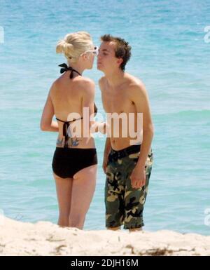 Exclusive!! Love blooms for Frankie Muniz and fiancee Jamie Gandy on Miami Beach. The couple collected sea shells together and kissed in the surf during the filming of Frankies new movie 'My Sexiest Year'. 5/5/06 Stock Photo