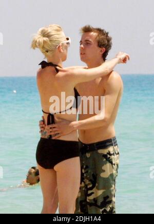 Exclusive!! Love blooms for Frankie Muniz and fiancee Jamie Gandy on Miami Beach. The couple collected sea shells together and kissed in the surf during the filming of Frankies new movie 'My Sexiest Year'. 5/5/06 Stock Photo